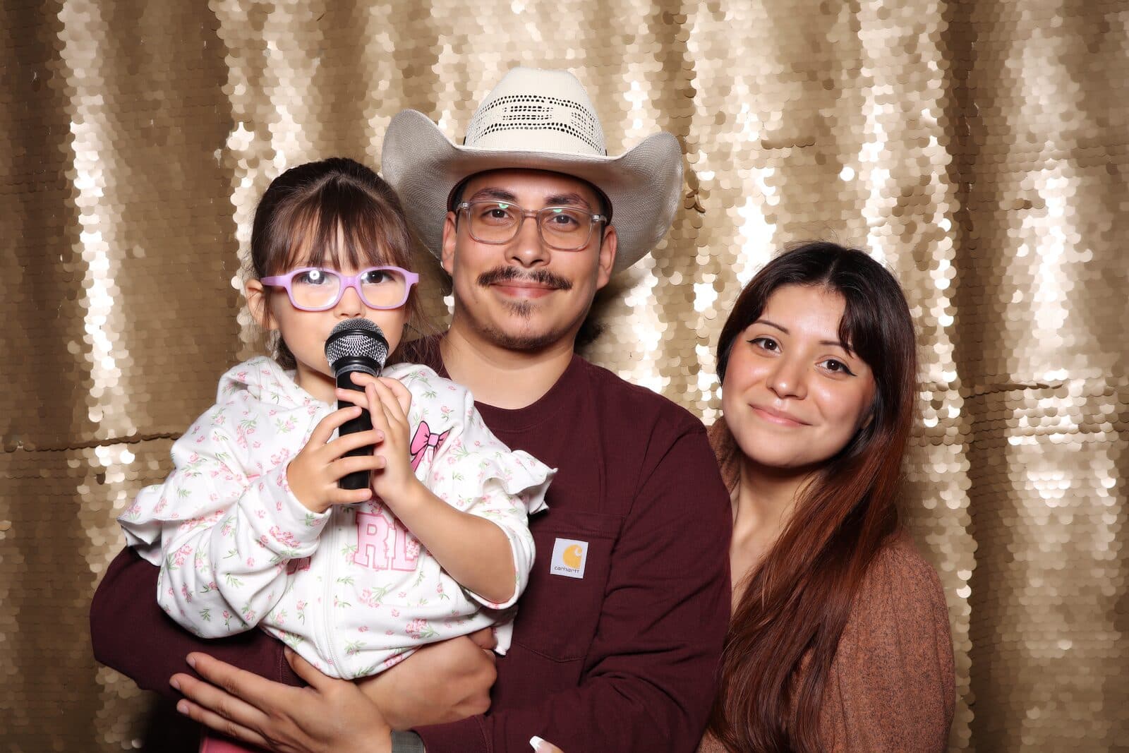 A family in a cowboy hat at the Shutter Bar photo booth